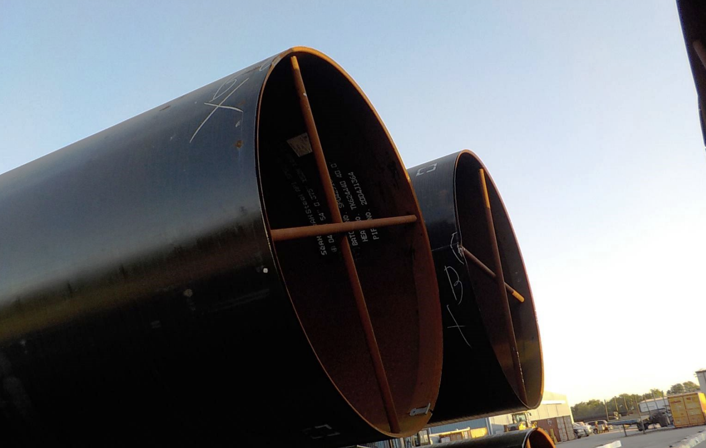 Stacked large-diameter steel pipe against open sky